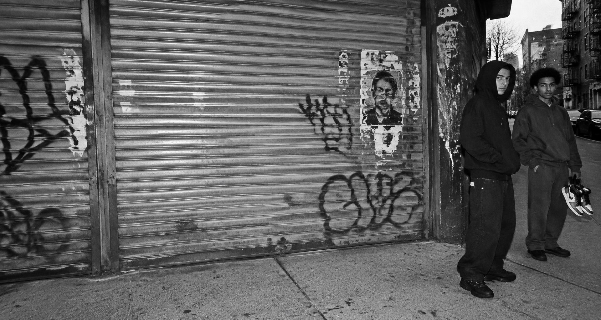New York streetwear outside a graffiti-covered storefront